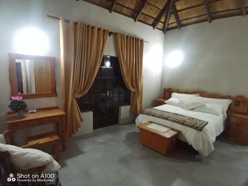 a bedroom with a bed and a window at Kataluma in Pretoria