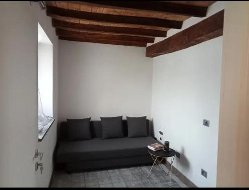 a living room with a couch and a table at b&b La Divina Pietra in Carnola
