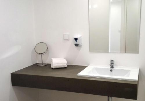 a bathroom with a sink and a mirror at Florasol Residence Hotel - Dorisol hotels in Funchal