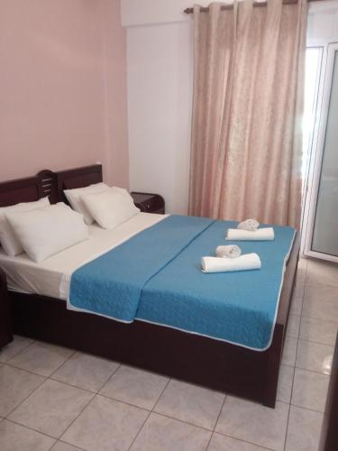 a bedroom with a bed with two towels on it at Studio Nikol koutsoupia in Kókkinon Nerón