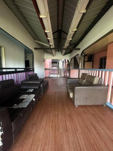 a room with couches and tables in a train car at Ren-Hana Kundasang in Kundasang