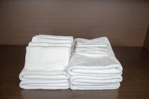 a stack of white towels sitting on a table at トワイライトヒルズ Twilight Hills in Motobu