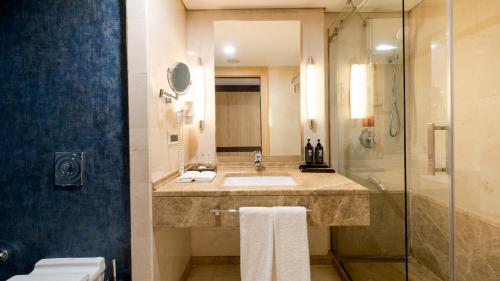 a bathroom with a sink and a shower at Ramada Plaza By Wyndham Istanbul City Center in Istanbul