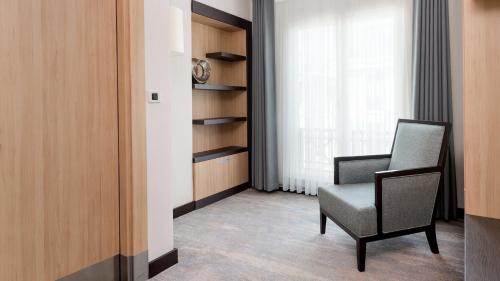 a room with a chair and a window at Ramada Plaza By Wyndham Istanbul City Center in Istanbul