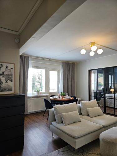 a living room with a couch and a table at Little Paris, 1 bedroom apartment in Pietarsaari