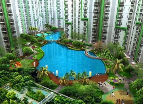 an aerial view of a large pool in the middle of buildings at Apartemen Green Lake View Ciputat by My Rooms in Pondokcabe Hilir