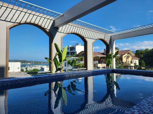 a swimming pool in a house with a view of the water at Benzen villa in Nha Trang