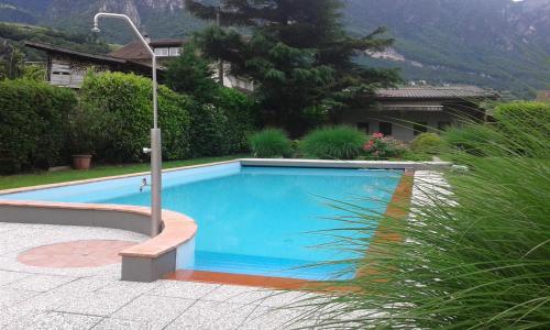 a large blue swimming pool in a yard at Dependance Villnerhof in Egna