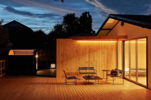 a patio with two chairs and a table on a building at VOYAN RESORT 伊豆MADOKA in Futo