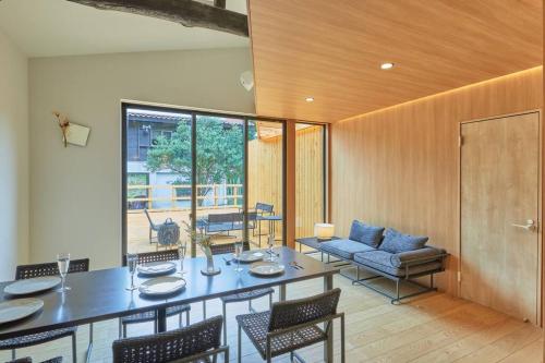 a dining room with a table and chairs at VOYAN RESORT 伊豆MADOKA in Futo