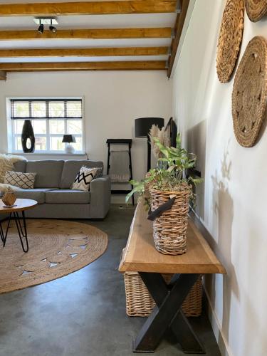 a living room with a couch and a table at Vakantie-Appartement WedderheideHoeve in Wedde