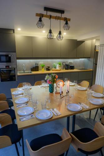 a kitchen with a table with plates and glasses at Forest Spa House in Gyueshevo