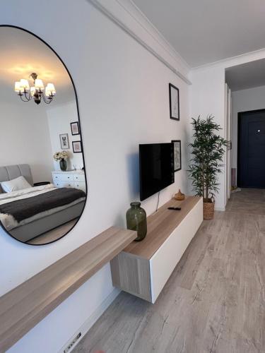a living room with a large mirror on the wall at Amena Residence in Chiajna