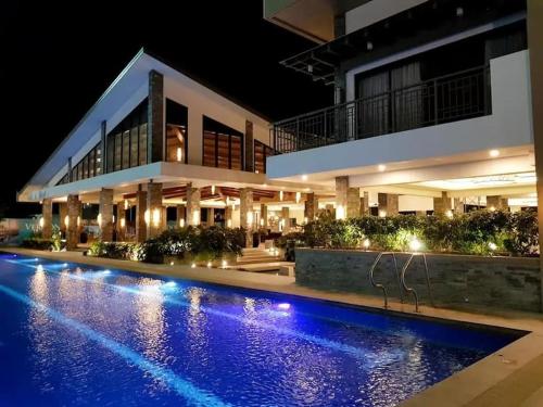 a house with a swimming pool at night at Verdon Parc 2 bedroom apartment Ocean View in Davao City