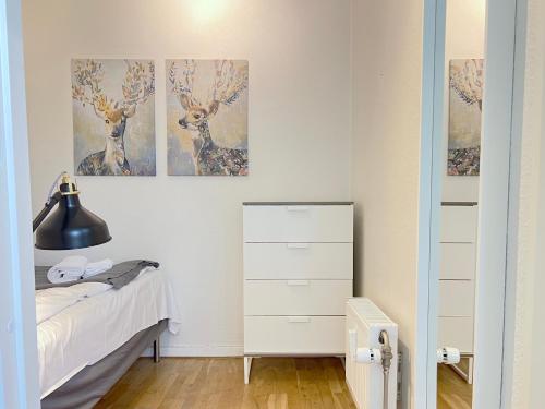 a bedroom with three deer paintings on the wall at Two Bedroom Apartment In Rdovre, Trnvej 39a, in Rødovre