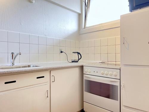 a kitchen with white appliances and a sink at Two Bedroom Apartment In Rdovre, Trnvej 39a, in Rødovre