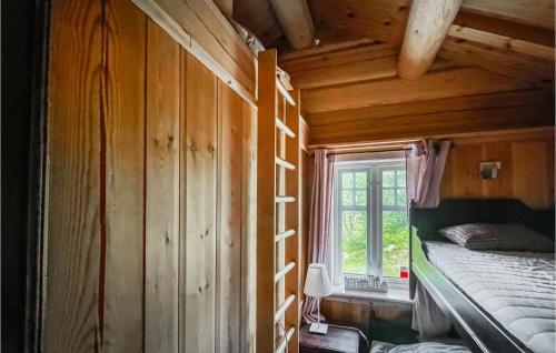 a bedroom with a bed and a window in a cabin at Beautiful Home In stby With Wifi And 5 Bedrooms in Østby
