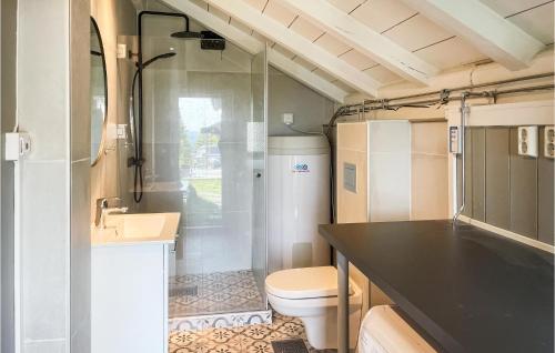 a small bathroom with a toilet and a sink at Beautiful Home In stby With Wifi And 5 Bedrooms in Østby