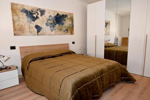 a bedroom with a bed and a map on the wall at Il Sogno in Acquapendente