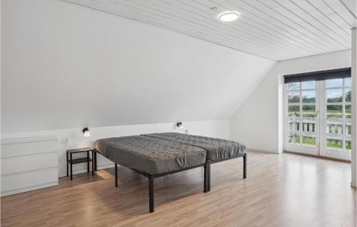 a bedroom with a bed in a white room at Beautiful Apartment In Gandrup With Wifi And 3 Bedrooms 