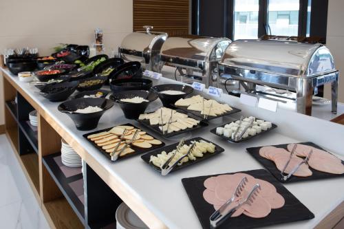 a buffet with many different types of food on a table at Batumi View Luxury in Batumi