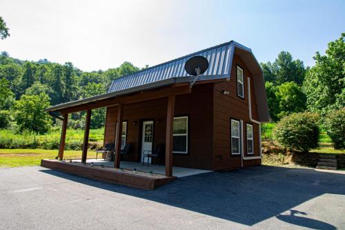 a small house with a gambrel roof on a lot at Mountain Haven Dragon's Nest Cabin in Robbinsville