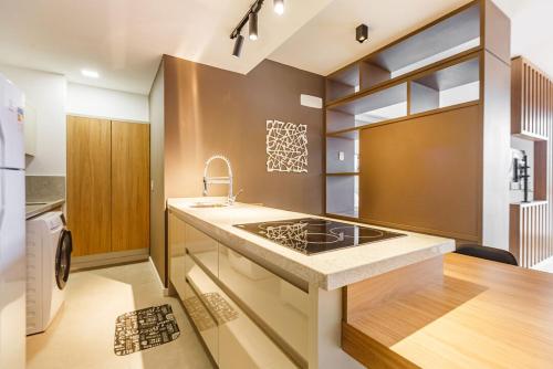 a kitchen with a sink and a stove at Apto com incrivel localizacao em Porto Alegre SP in Porto Alegre