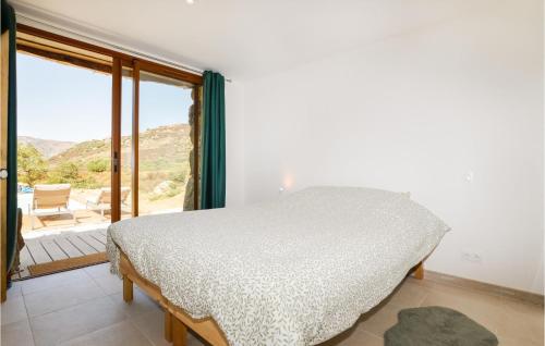 a bedroom with a bed and a large window at Awesome Home In Feliceto With House A Mountain View in Feliceto