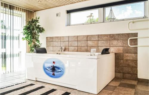 a bathroom with a white counter with a sink at Pet Friendly Home In Hvide Sande With Kitchen in Havrvig