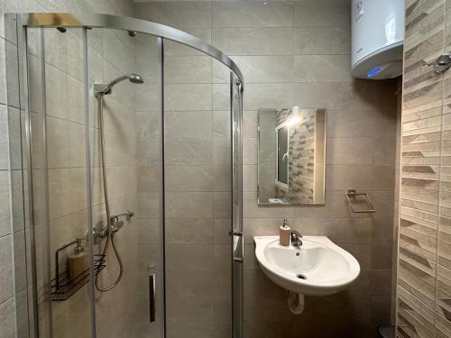 a bathroom with a shower and a sink at DoMiSol duplex suites near sea in St. Paul's Bay