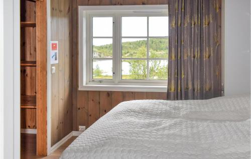a bedroom with a bed and a window at Amazing Home In Eggedal With Sauna And 6 Bedrooms in Eggedal