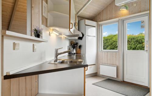 a kitchen with a sink and a window at Stunning Apartment In Rønde With Sauna in Rønde
