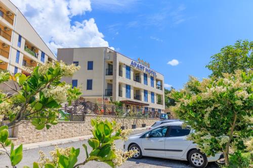 a car parked in front of a building at Apart hotel M S KATUNJANIN in Herceg-Novi