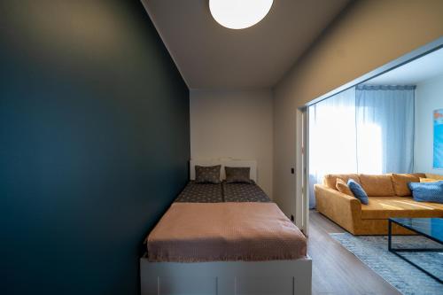 a bedroom with a bed and a couch at Trendy Kentmanni, city center apartment in Tallinn