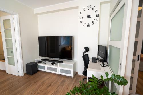 a living room with a flat screen tv on a wall at Trendy Kentmanni, city center apartment in Tallinn