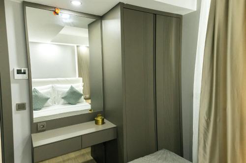 a bathroom with a mirror and a sink and a toilet at Leaf River Suites in Antalya