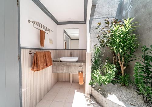 a bathroom with a sink and a mirror at Tropical Tree in Fehendhoo