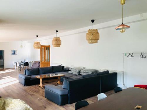a living room with a couch and a table at The Hygge House in Plopi
