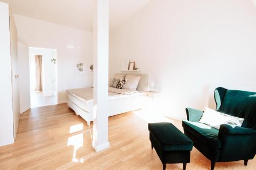 a living room with a couch and a bed at Deichstadt Apartments in Neuwied