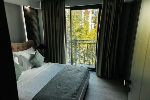 a hotel room with a bed and a balcony at Leaf River Suites in Antalya