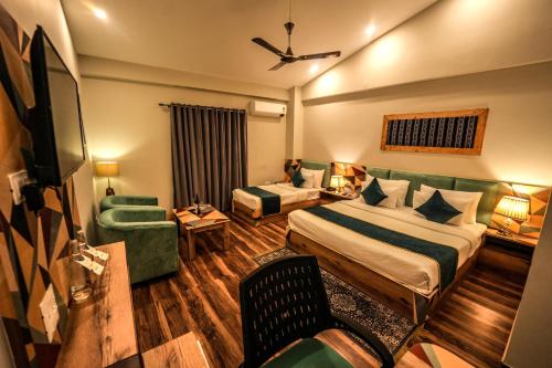 a hotel room with a bed and a couch at Hotel Square One by D'Polo Dharamshala in Dharamshala
