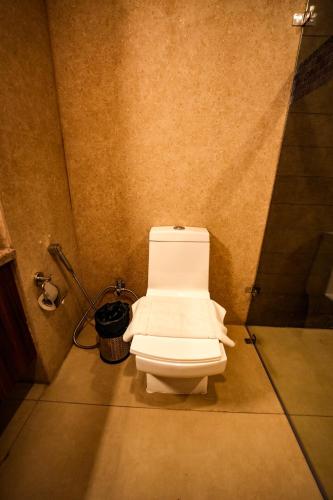a bathroom with a white toilet in a room at Hotel Square One by D'Polo Dharamshala in Dharamshala