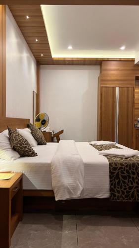 a hotel room with two beds and a desk at The Wild Trails Clarks Exotica , Munnar in Munnar