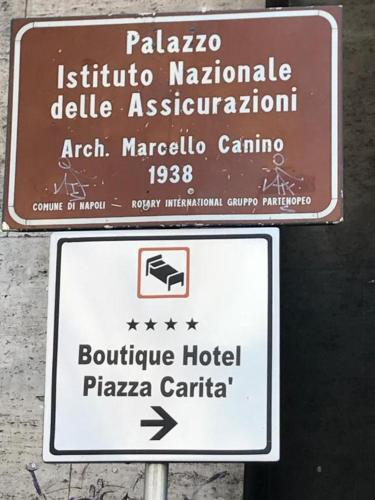 a sign for a hotel in a foreign country at Boutique Hotel Piazza Carità in Naples
