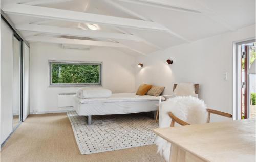 a living room with a couch and a window at Cozy Home In Frvang With Outdoor Swimming Pool in Fårvang