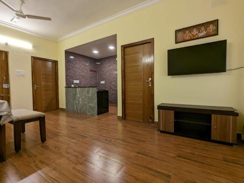 a living room with a flat screen tv on the wall at 2A Villa Innocent in Puducherry