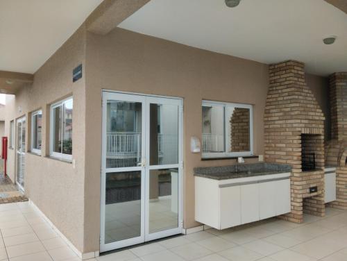 a bathroom with a sink and a brick wall at Alcimar Zuzo in Mogi das Cruzes