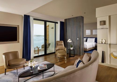 a living room with a couch and a room with a bed at Grand Hotel Brioni Pula, A Radisson Collection Hotel in Pula