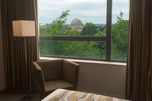 a room with a chair and a large window at Park Plaza Cardiff in Cardiff