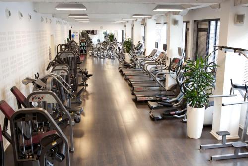 a gym with a row of exercise bikes and plants at Park Plaza Cardiff in Cardiff